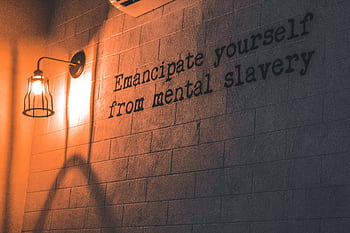 A wall lamp casts a warm glow on an inspirational quote about mental dom. HD wallpaper