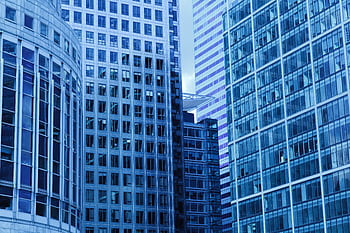 A close-up view of modern skyscrapers with glass facades in a cityscape. HD wallpaper