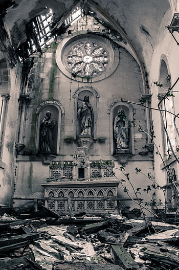 Captivating view of an abandoned church altar with religious statues and dilapidated surroundings. HD phone wallpaper