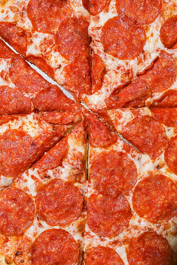 Close-up of a cheesy pepperoni pizza with mouth-watering toppings. HD phone wallpaper