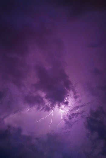 A vivid lightning strike illuminates dark clouds during a dramatic nighttime thunderstorm. HD phone wallpaper