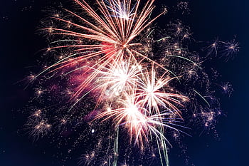 Colorful fireworks exploding in the night sky creating a festive atmosphere. HD wallpaper