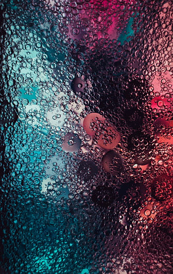 Vibrant macro shot of colorful water droplets on a textured surface, creating an abstract art pattern. HD phone wallpaper