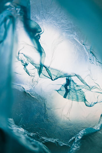 Artistic close-up of translucent plastic texture in blue tones, creating a soft and dreamy atmosphere. HD phone wallpaper
