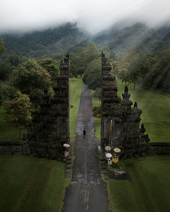 A stunning aerial view of the iconic Handara Gate amidst lush greenery in Bali, Indonesia. HD phone wallpaper