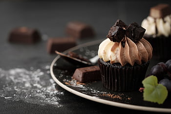 Decadent chocolate cupcake with rich cream and chocolate chunks, perfect for indulgence. HD wallpaper