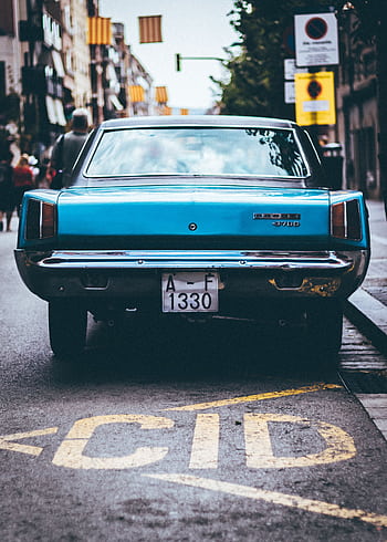 A classic Dodge vehicle parked on an urban street in Barcelona, showcasing vintage charm. HD phone wallpaper