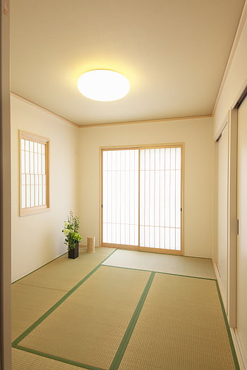 Elegant Japanese-style room with tatami mats and wooden sliding doors. HD phone wallpaper