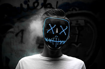 Dark portrait of a person wearing a glowing LED mask creating a Halloween vibe. HD wallpaper
