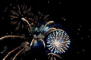 Vibrant fireworks illuminate the night sky, celebrating a festive event with bright and vivid explosions. HD wallpaper