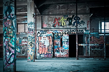 Colorful graffiti art on the walls of an abandoned building, showcasing urban street art culture. HD wallpaper