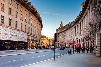 A bustling view of Regent Street in London with historic architecture and lively street life. HD wallpaper