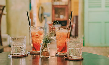 Close-up of refreshing lychee cocktails served with ice, perfect for indoor summer gatherings. HD wallpaper