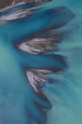 Stunning aerial shot showcasing unique blue water formations near Sibbald, New Zealand. HD phone wallpaper