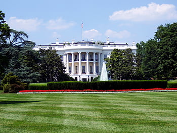 Iconic view of the White House with lush gardens and a central fountain on a sunny day. HD wallpaper