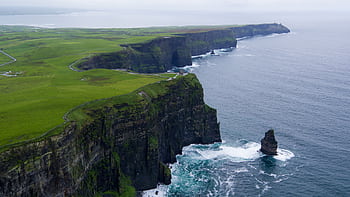 Stunning aerial view of the Cliffs of Moher, County Clare, Ireland with lush green landscapes and ocean waves. HD wallpaper