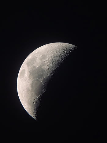 High-resolution capturing the detailed surface of the crescent moon against a dark sky. HD phone wallpaper
