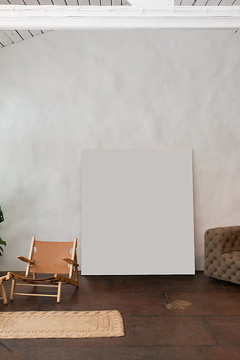 Stylish minimal interior featuring armchair, sofa, and blank canvas for design or mockup. HD phone wallpaper