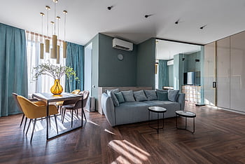Spacious modern living room with elegant decor, featuring a cozy sofa and stylish dining area. HD wallpaper