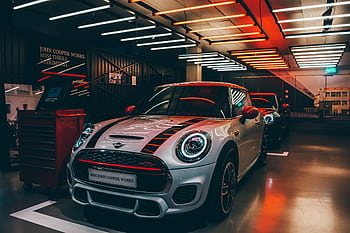 Vibrant Mini Cooper display in a stylish showroom with striking lighting. HD wallpaper