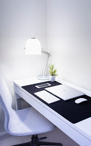 Sleek, modern home office setup featuring Apple devices, a desk lamp, and a plant. HD phone wallpaper