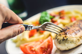 A vibrant close-up of a flavorful grilled chicken meal with pasta and veggies. HD wallpaper
