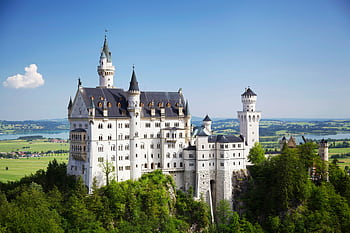 A stunning view of Neuschwanstein Castle amidst Bavaria's lush landscapes. HD wallpaper