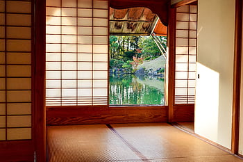 Traditional Japanese room with shoji screens and a view of a serene garden pond. HD wallpaper