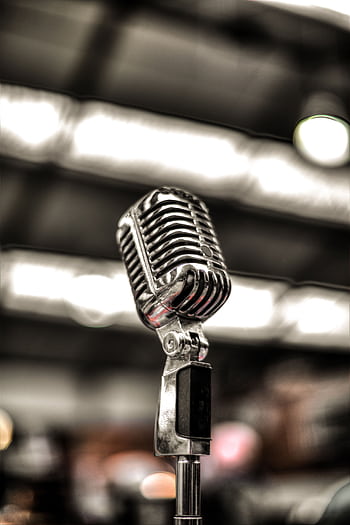 Close-up of a vintage chrome micro on a blurred stage background, ideal for music themes. HD phone wallpaper