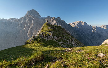 Experience the serene beauty of the Julian Alps, captured in daylight with lush green pastures and towering peaks. HD wallpaper