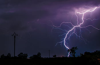 A stunning lightning strike captured during a thunderstorm in Flavin, Occitanie, France. HD wallpaper