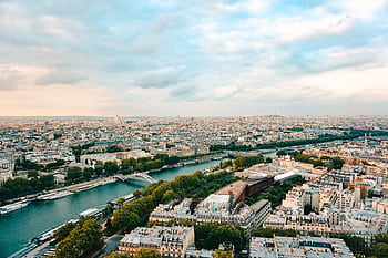 A stunning aerial view of Paris, showcasing the Seine River and iconic landmarks during sunset. HD wallpaper