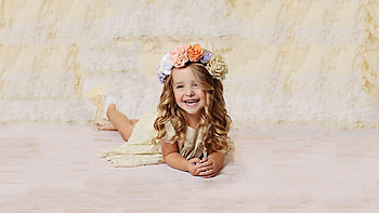 Smiling Curly Hair Cute Little Girl Is Lying Down On Floor Wearing Light Yellow Dress And Wreath Cute HD wallpaper