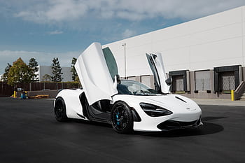 Dynamic white supercar with open doors showcasing elegance and modern design. HD wallpaper