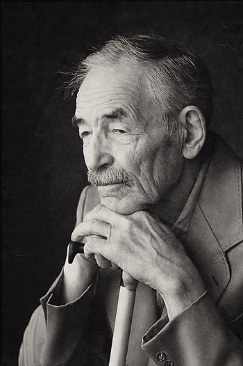 Thoughtful elderly man with cane, captured in a contemplative black and white portrait. HD phone wallpaper