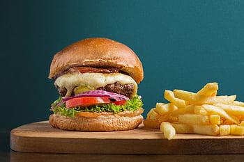 A delicious cheeseburger served with crispy golden french fries, perfect for a tasty meal. HD wallpaper