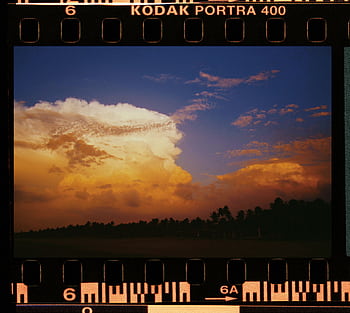 Capture of a vibrant sunset with dramatic clouds on Kodak Portra 400 film. HD wallpaper