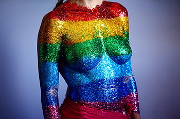 A colorful body art showcasing the LGBTQ pride with glitter stripes, celebrating diversity and expression. HD wallpaper