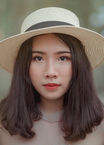 Stunning portrait of a young woman wearing a stylish hat outdoors. HD phone wallpaper