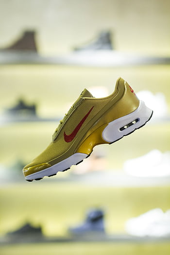 Stylish yellow sneaker showcased with blurred store background for a trendy vibe. HD phone wallpaper