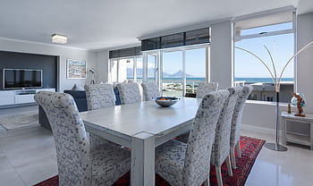 Luxurious dining room in Cape Town with modern furniture and ocean views. HD wallpaper