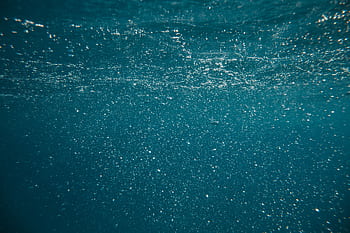 Enchanting underwater view with bubbles and shimmering light creating a mystical atmosphere. HD wallpaper