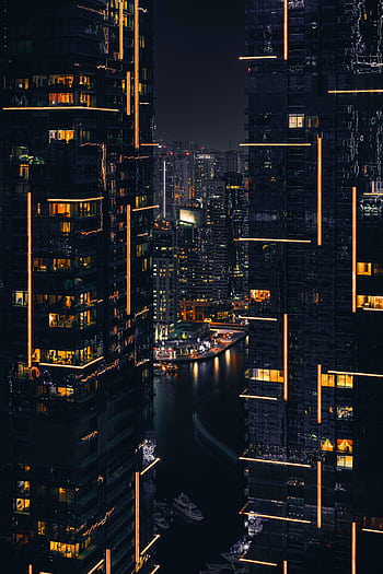 Captivating night view of Dubai skyscrapers illuminated against the dark sky. Perfect for tech and urban themes. HD phone wallpaper