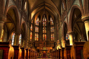Intricate architecture of a historic church interior with stained glass windows. HD wallpaper