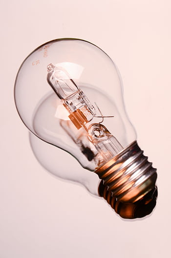 Detailed of a classic clear incandescent bulb, encapsulating energy and innovation concepts. HD phone wallpaper