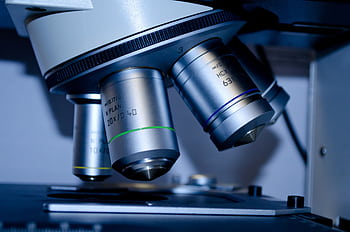Detailed view of optical microscope lenses in a laboratory setting. HD wallpaper