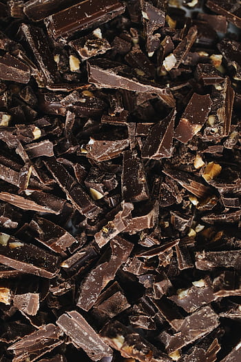 A detailed view of broken chocolate pieces showcasing texture and indulgence. HD phone wallpaper