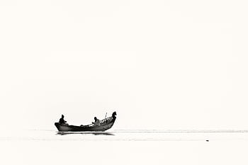 Silhouetted fishermen in a boat on a tranquil water body, showcasing minimalism in black and white. HD wallpaper
