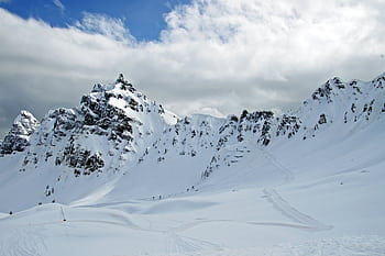 Breathtaking snowy mountain with clear skies, ideal for winter sports and adventure. HD wallpaper