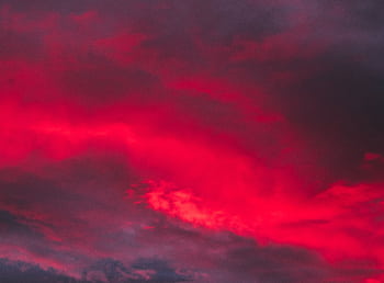 Captivating red clouds at dusk creating a dramatic sky scene. HD wallpaper